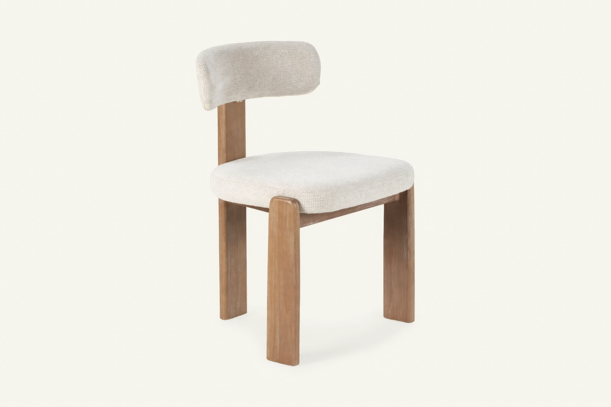 The Orta Dining Chair in ivory, upholstered dining chair on a wooden frame, studio view
