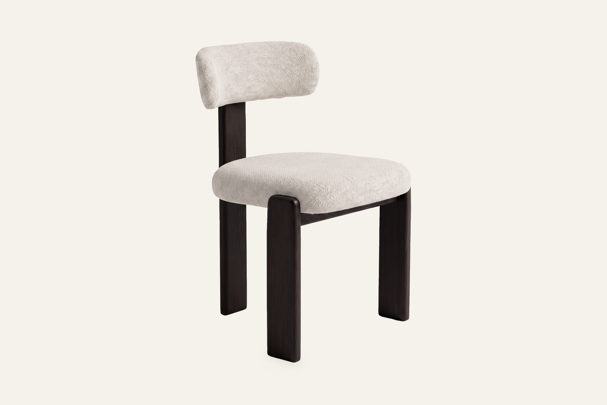 The Orta Dining Chair in ivory on a walnut frame, upholstered dining chair, studio view