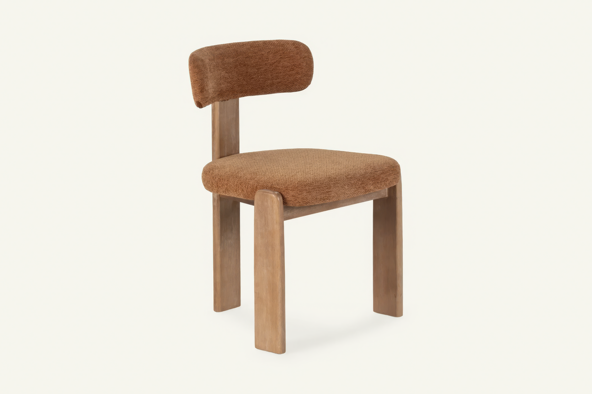 The Orta Dining Chair in terracotta, upholstered dining chair on a wooden frame, studio view