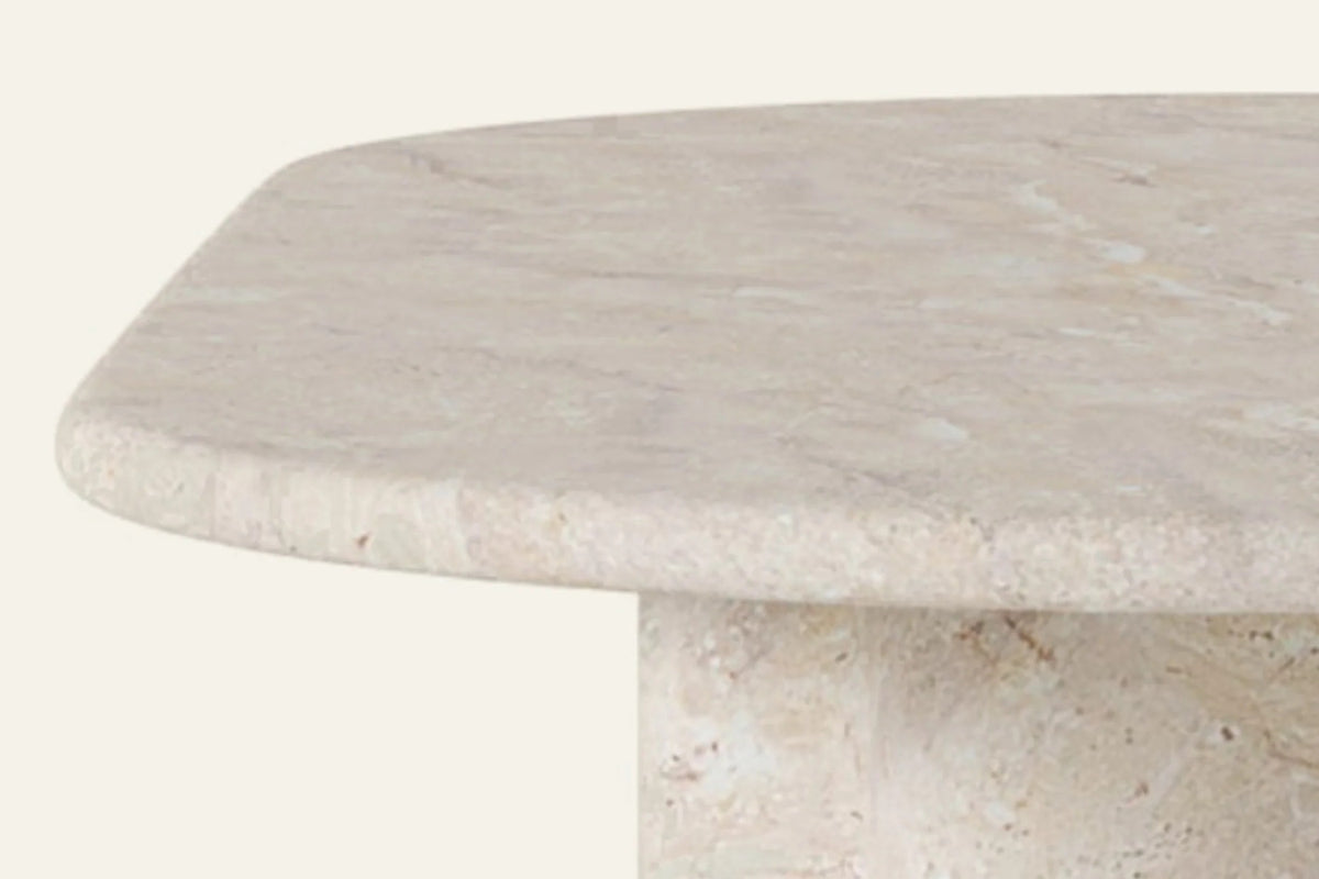 The Ortigia Travertine Finish Dining Table, close-up of the rounded travertine-finish edge