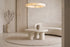 The Otranto Coffee Table, round cream concrete-effect coffee table, styled in a room