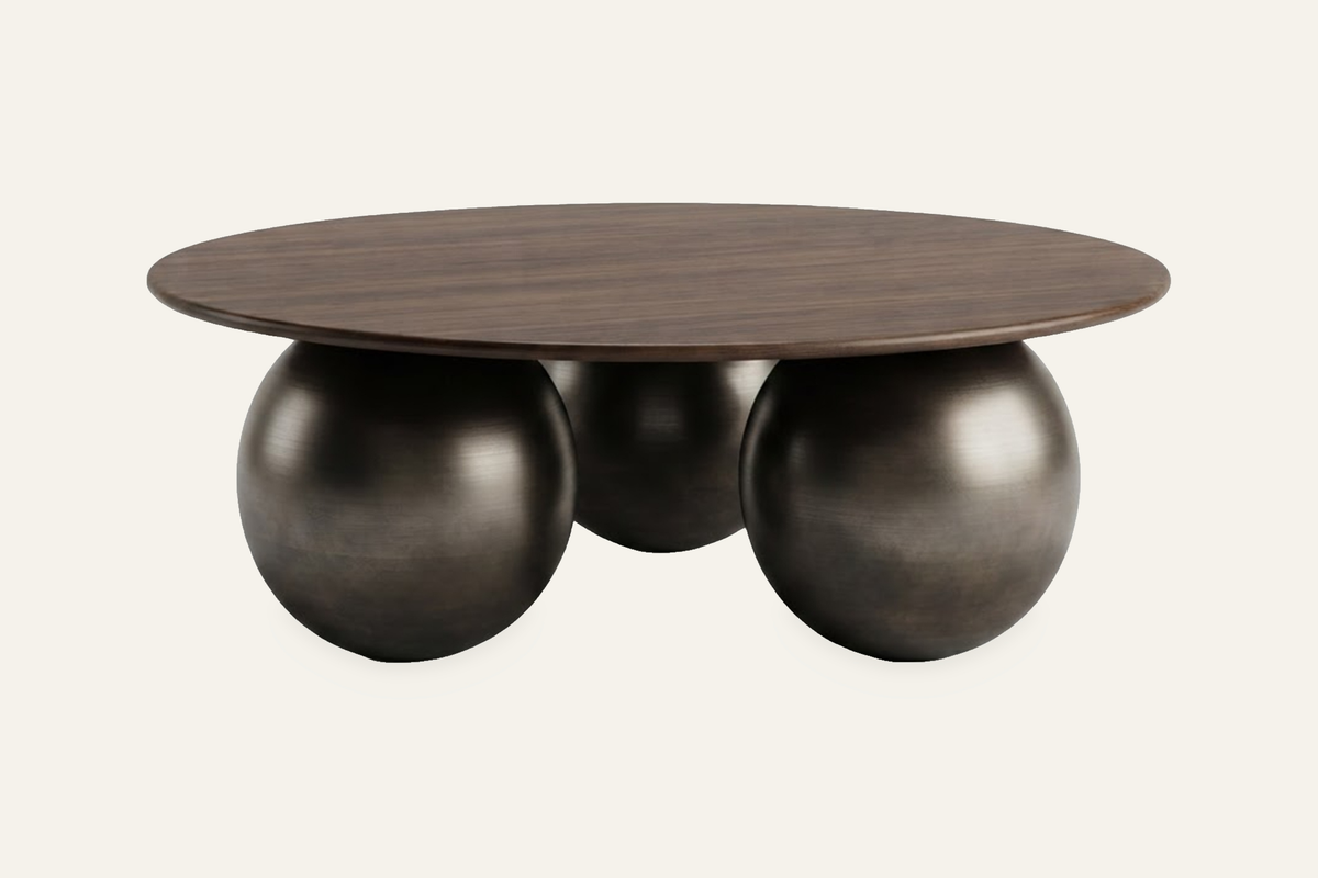 The Pietrasanta Coffee Table in dark walnut, round coffee table on spherical feet, studio view