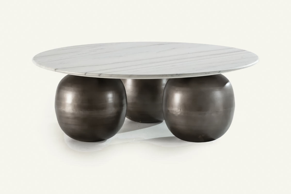 The Pietrasanta Coffee Table, round white marble coffee table on spherical feet, studio view