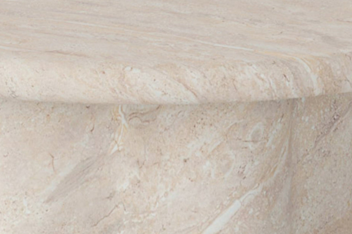 The Ragusa Travertine Finish Coffee Table Set, close-up of the rounded top edge and sculpted pedestal in the travertine finish