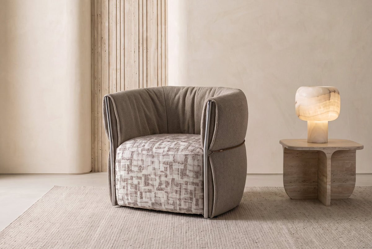 The Rapallo Accent Chair with ruched shell and patterned seat in a plaster room
