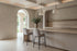 Two Riomaggiore Counter Stools in light grey at a kitchen island beneath alabaster pendants and a coffered ceiling