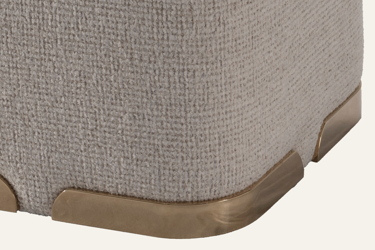 The Sabbia Pouf, close-up of the boucle and gold-tone steel plinth