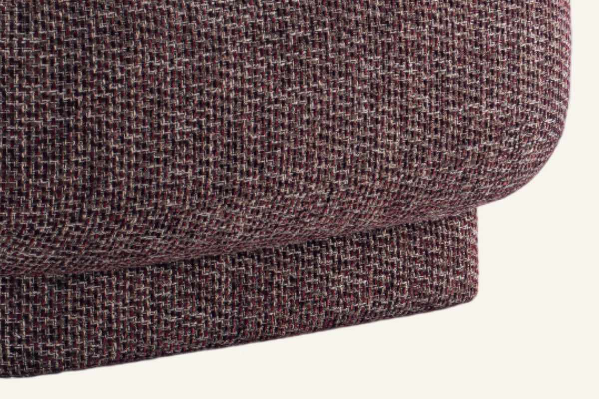 The Salina Armchair, close-up of the burgundy boucle at the base