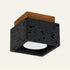 The Scatola travertine flush ceiling light, a square black stone box with a wood top, open underneath