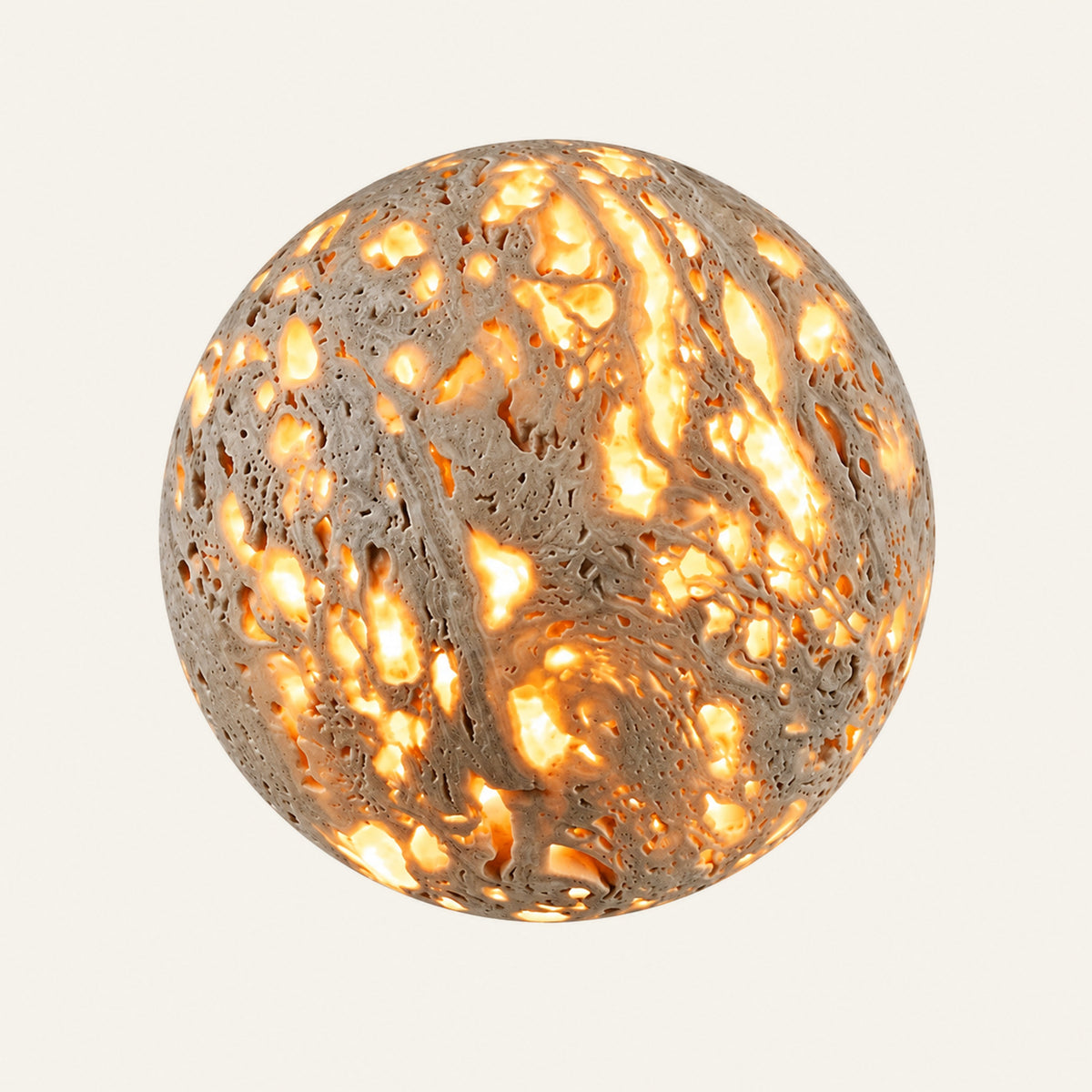 The Sfera travertine wall light, a round stone sphere glowing through its pores with rays of light on the wall