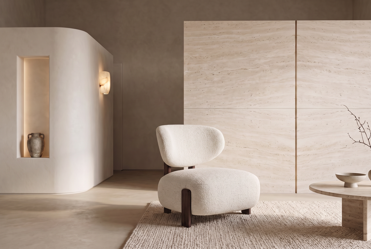 The Sirmione Lounge Chair in ivory boucle on a walnut frame, in a travertine and plaster living room