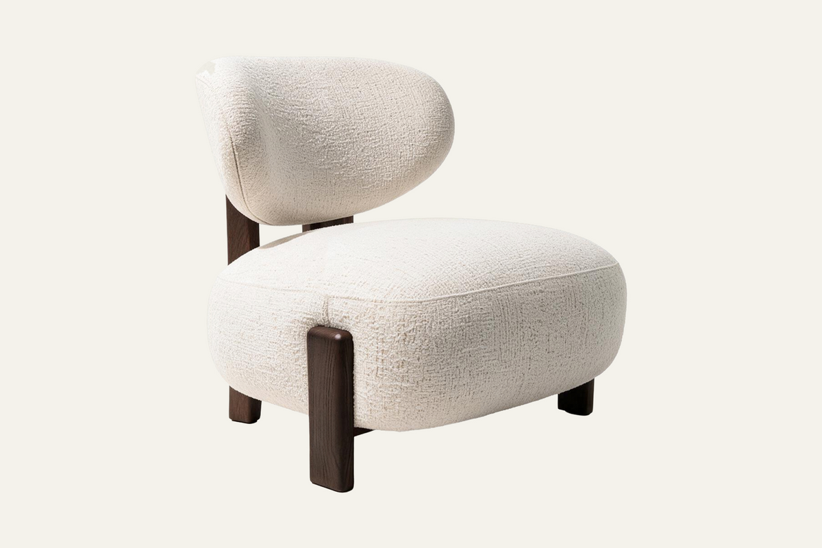 The Sirmione Lounge Chair in ivory, low lounge chair in textured fabric on a walnut frame, studio view
