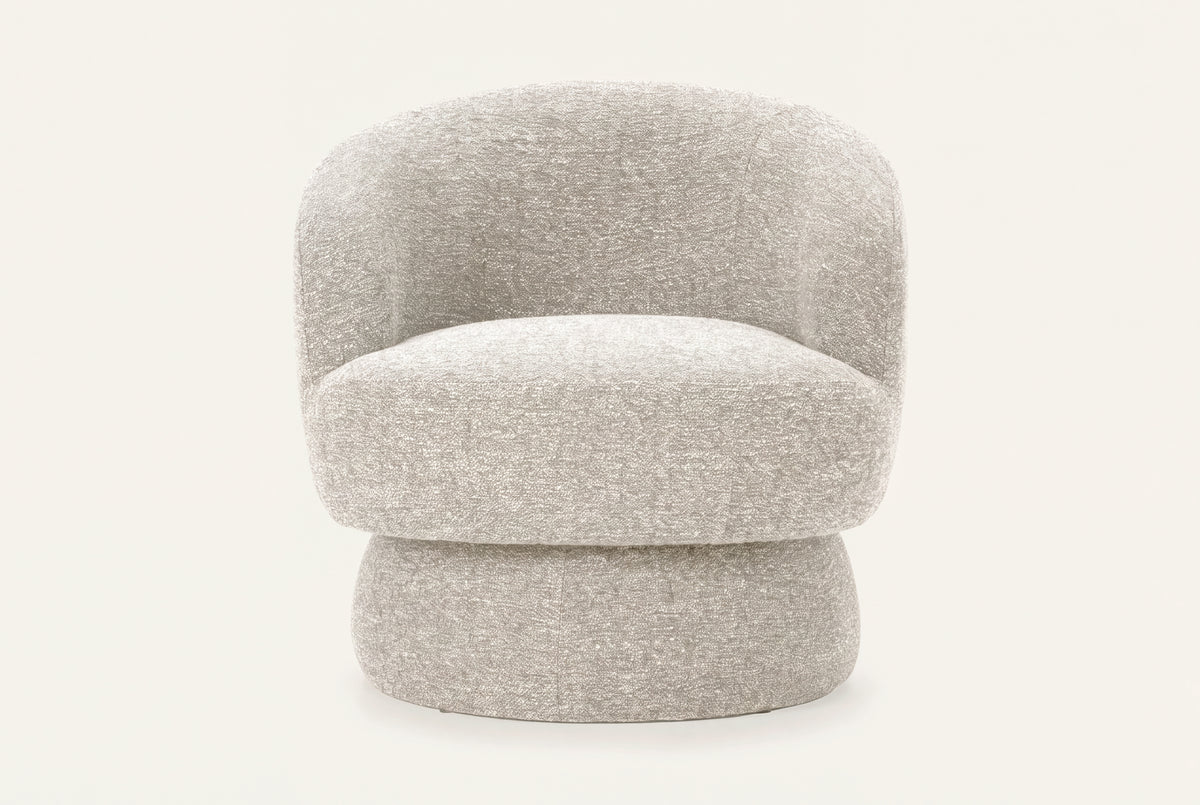 The Taormina Swivel Chair in stone, rounded boucle swivel chair, studio view
