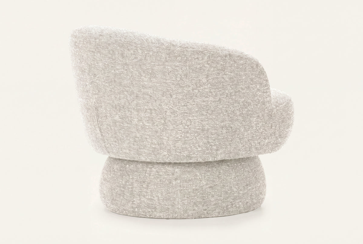 The Taormina Swivel Chair in stone, rounded boucle swivel chair, studio view