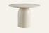 The Tellaro Round Dining Table in cream, cream cement-effect round dining table on a bell pedestal, studio view