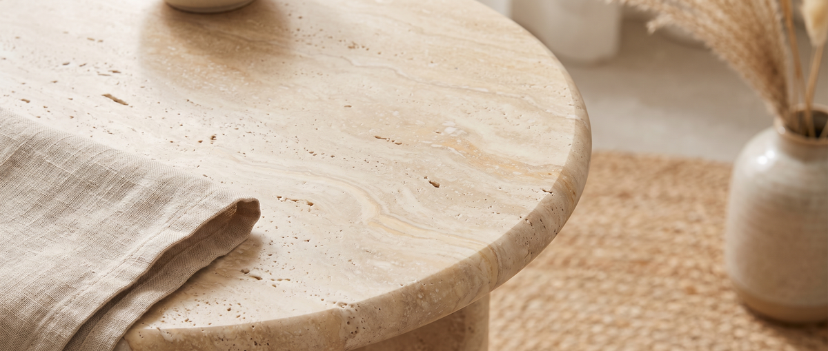 Close-up of a honed travertine table top with a linen napkin
