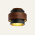 The Torre travertine flush ceiling light, stepped black stone tiers wrapped in a wide wood band
