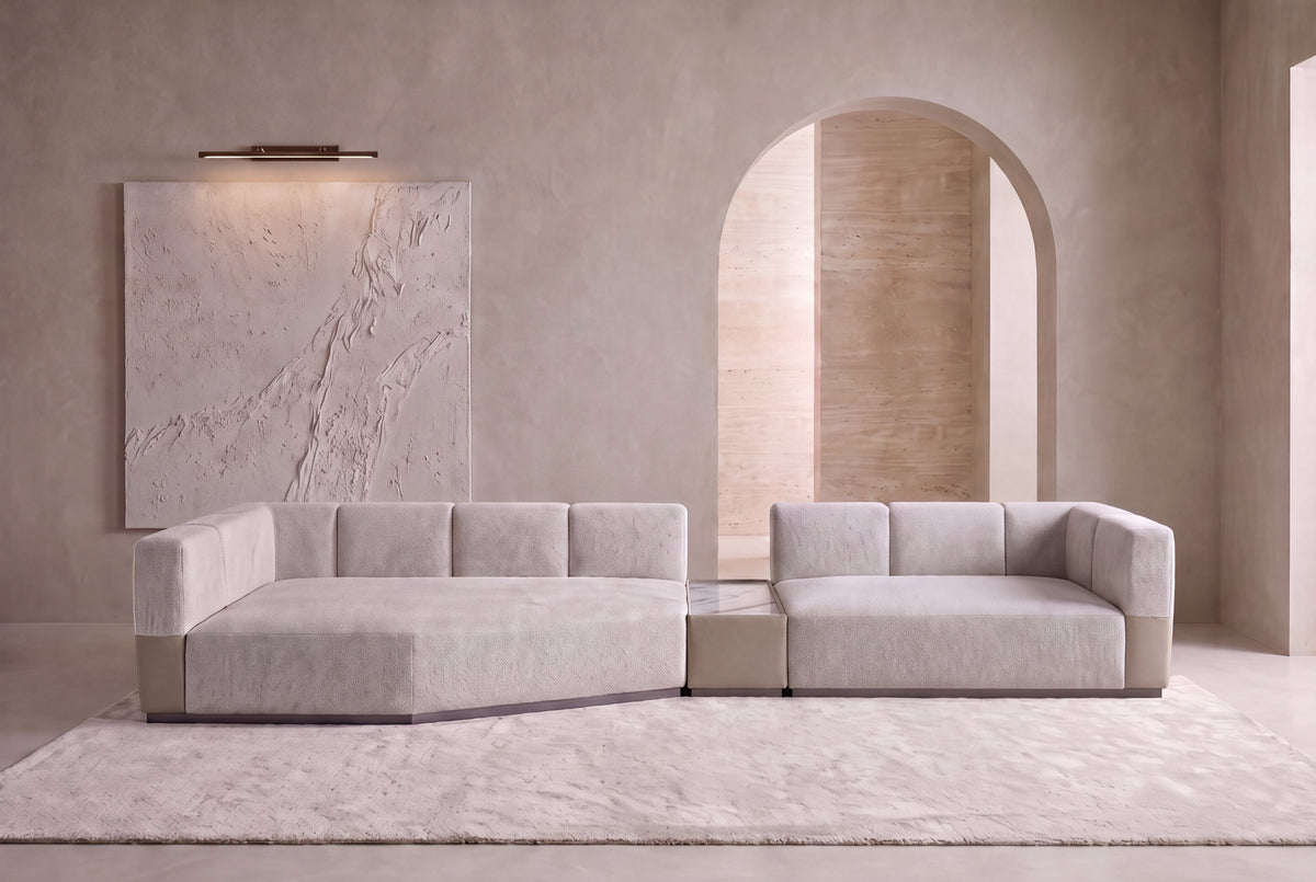 The Treviso Modular Sofa with built-in table and stone leather accents in an arched plaster living room