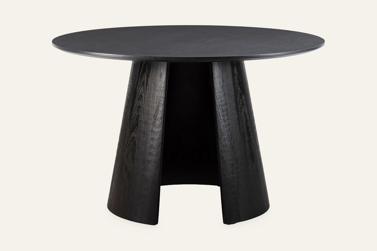 The Tropea Round Dining Table in black, round dining table on a curved panel pedestal, studio view