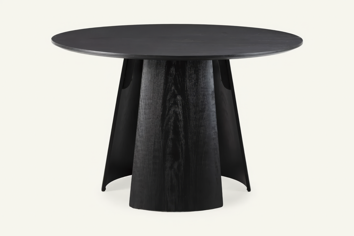 The Tropea Round Dining Table in black, round dining table on a curved panel pedestal, studio view
