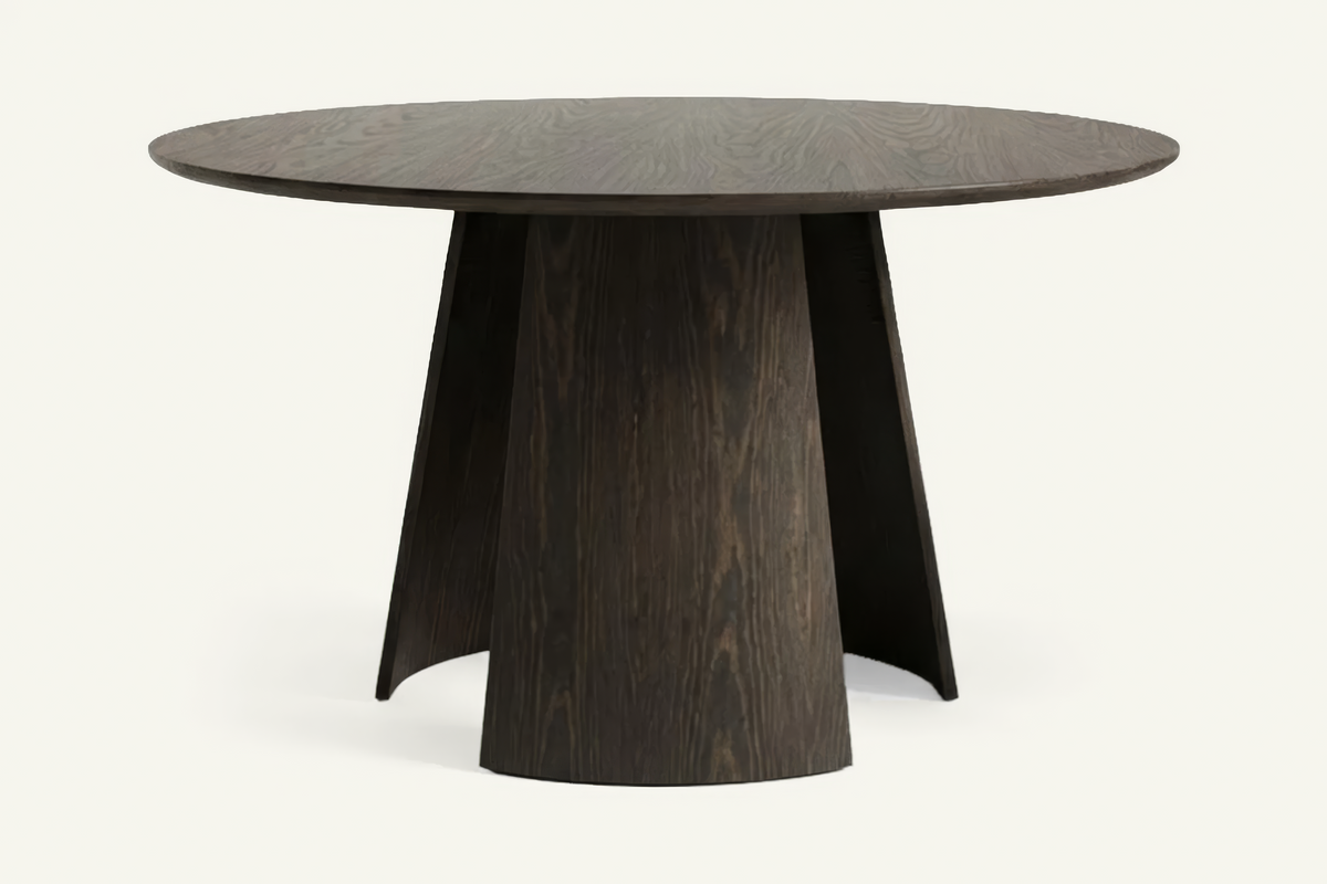 The Tropea Round Dining Table in walnut, round dining table on a curved panel pedestal, studio view