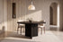 The Varese Round Dining Table with Norcia chairs beneath a Cupola alabaster pendant against a fluted travertine wall