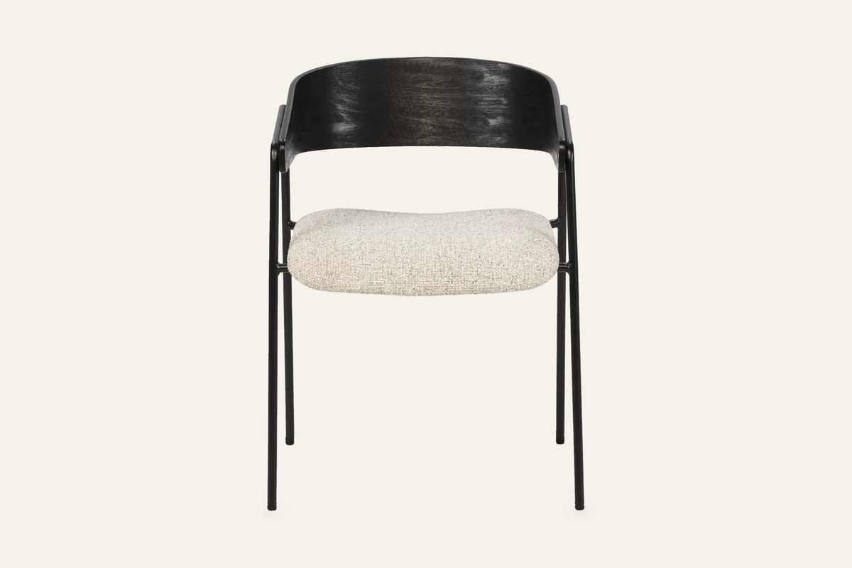 The Vernazza Dining Chair in black, dining chair with a curved wooden back on a metal frame, studio view