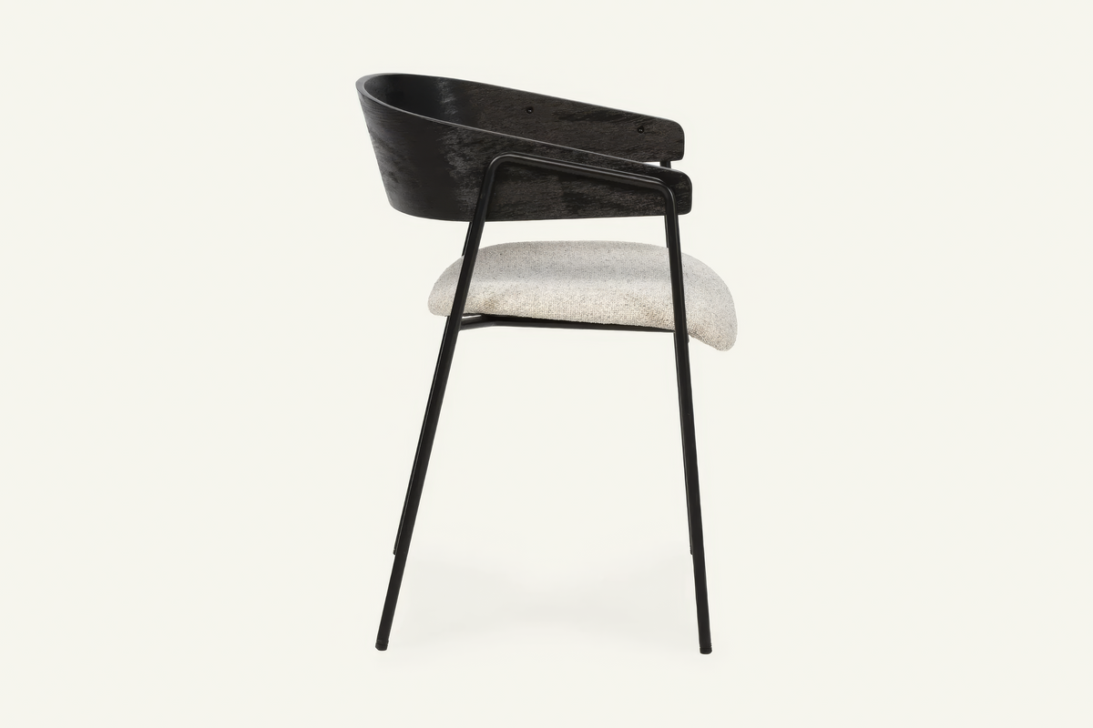 The Vernazza Dining Chair in black, dining chair with a curved wooden back on a metal frame, studio view