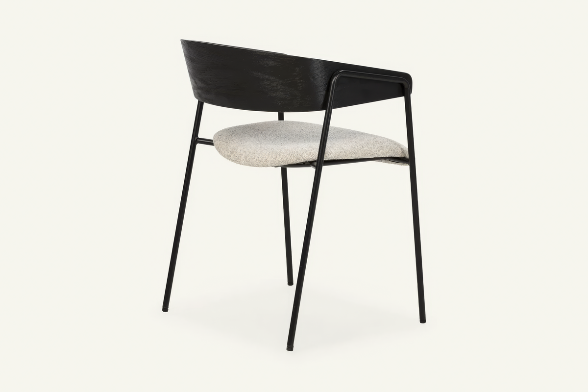 The Vernazza Dining Chair in black, dining chair with a curved wooden back on a metal frame, studio view