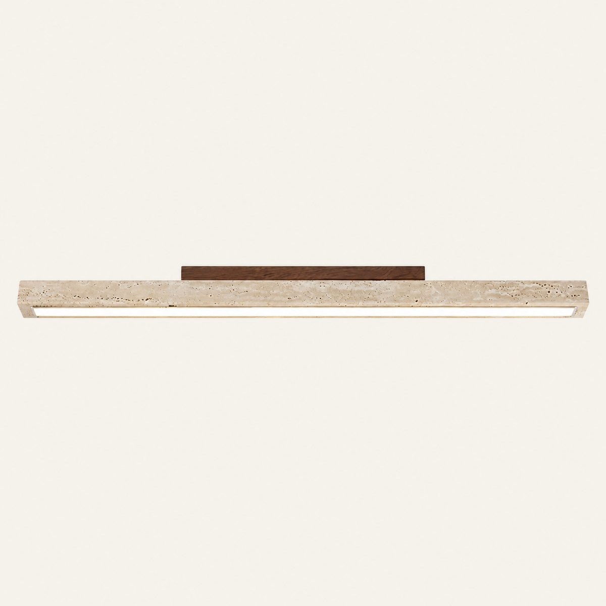 The Linea travertine flush ceiling light, a slim stone bar with a walnut mount
