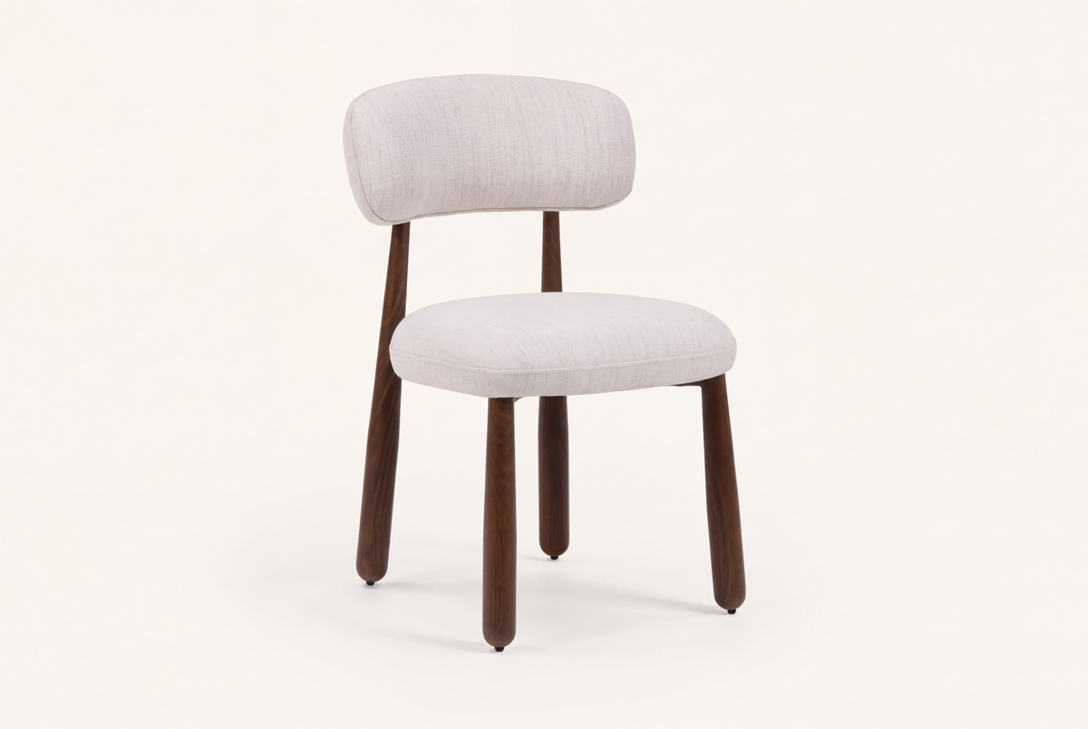 The Mantova Dining Chair in ivory and walnut, upholstered dining chair with a rounded back, studio view
