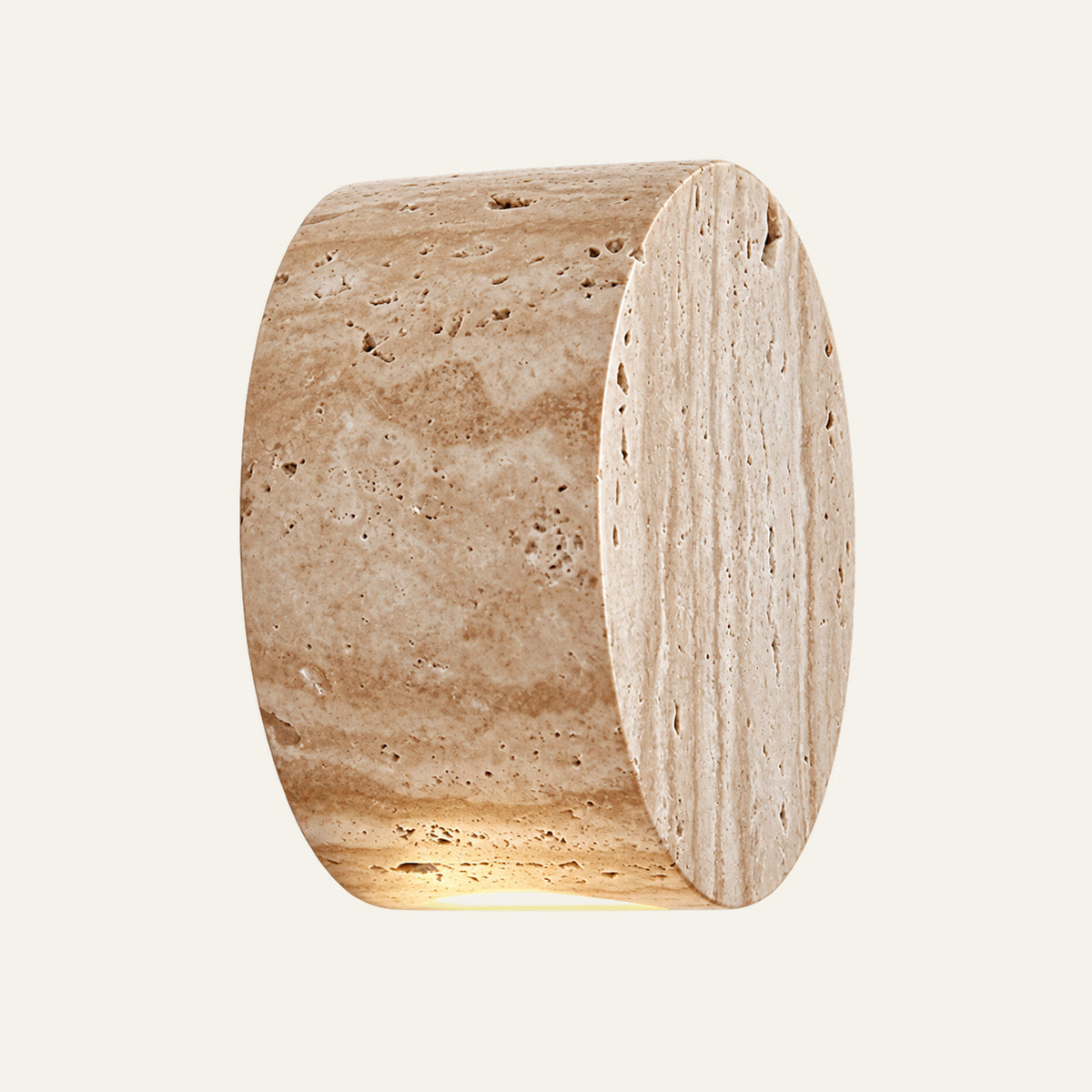 The Medaglia travertine wall light, a solid round stone drum