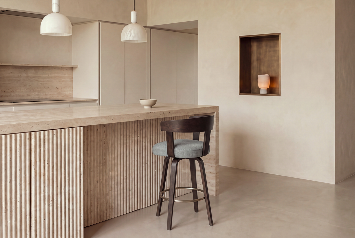 The Novara Swivel Bar Stool in grey and dark walnut at a fluted travertine kitchen island beneath Cupola alabaster pendants