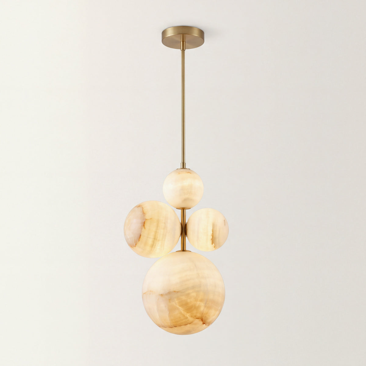 The Nuvola alabaster chandelier, four alabaster spheres clustered on a single brass rod