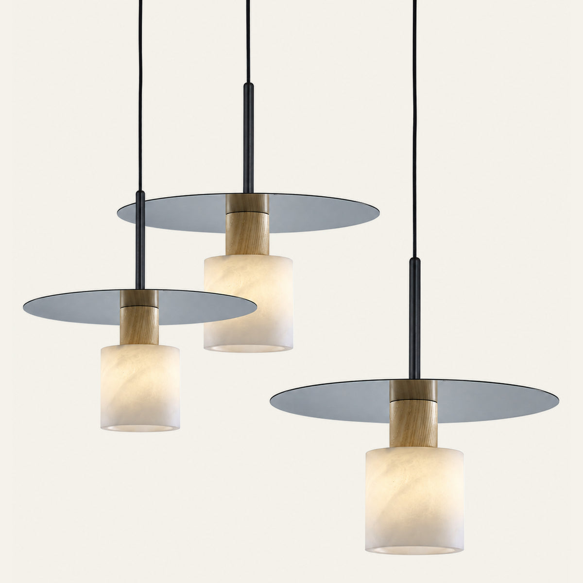 The Ombra alabaster pendant light shown in three disc sizes