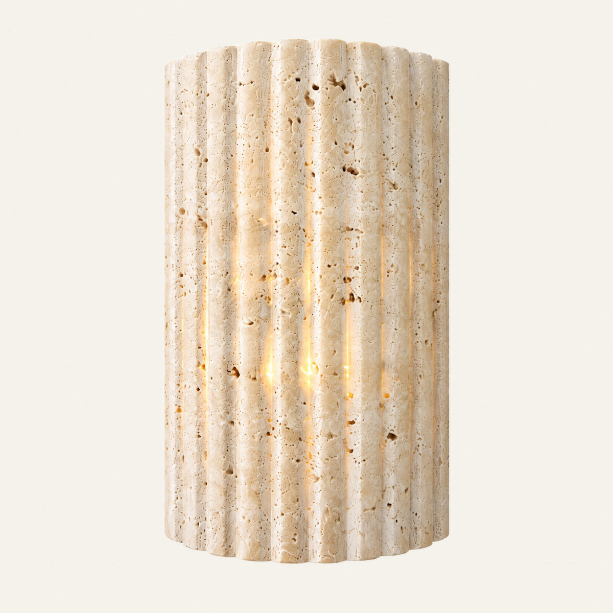 The Onda travertine wall light, a fluted stone half cylinder