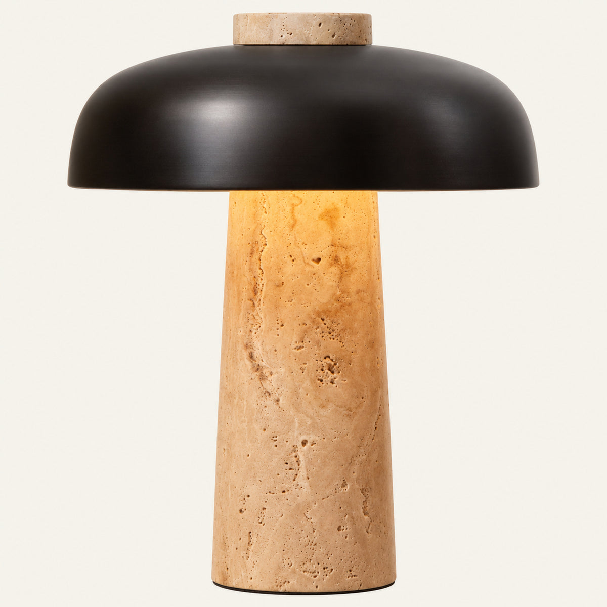 The Porcino travertine table lamp, a stone stem beneath a dark mushroom shade