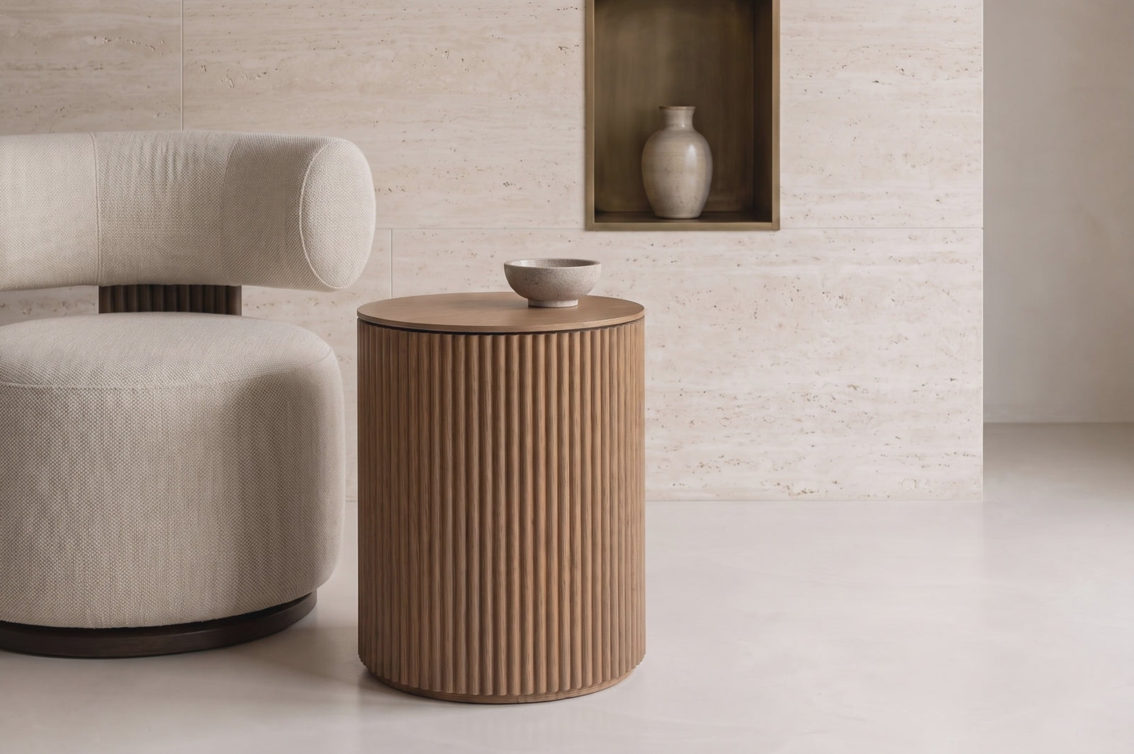 Barga fluted side table beside a boucle chair