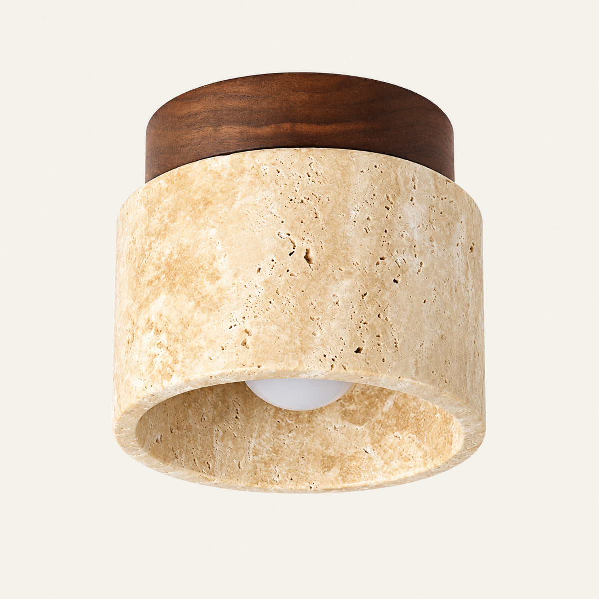 The Punto travertine flush ceiling light, a round stone downlight