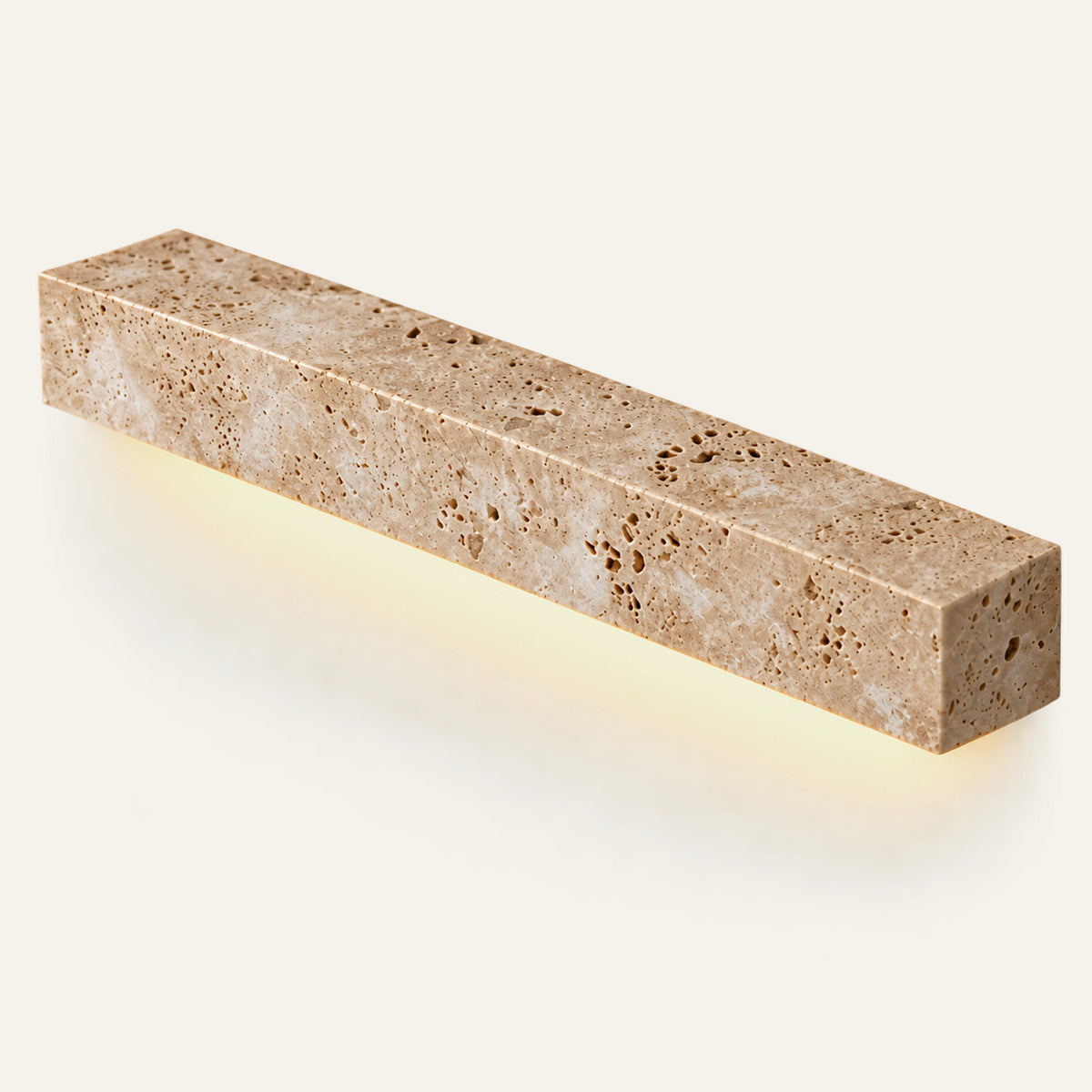 The Riga travertine wall light, L48cm, lit from below