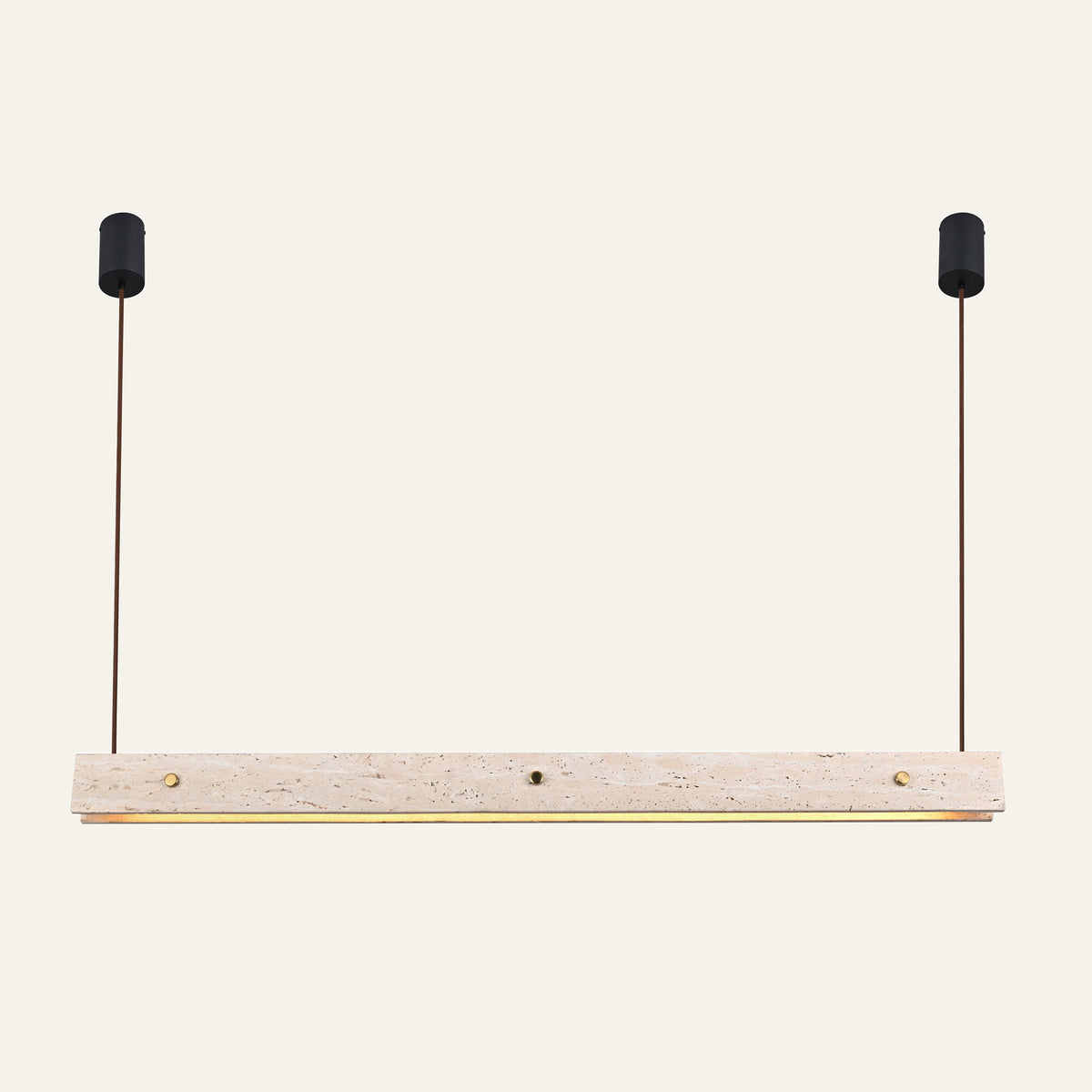 The Rivetto travertine linear pendant light, a long stone bar with brass studs on two black ceiling cups