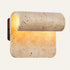 The Rotolo travertine wall light with a walnut mount