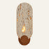 The Sentinella travertine wall light, an upright stone capsule on a walnut base