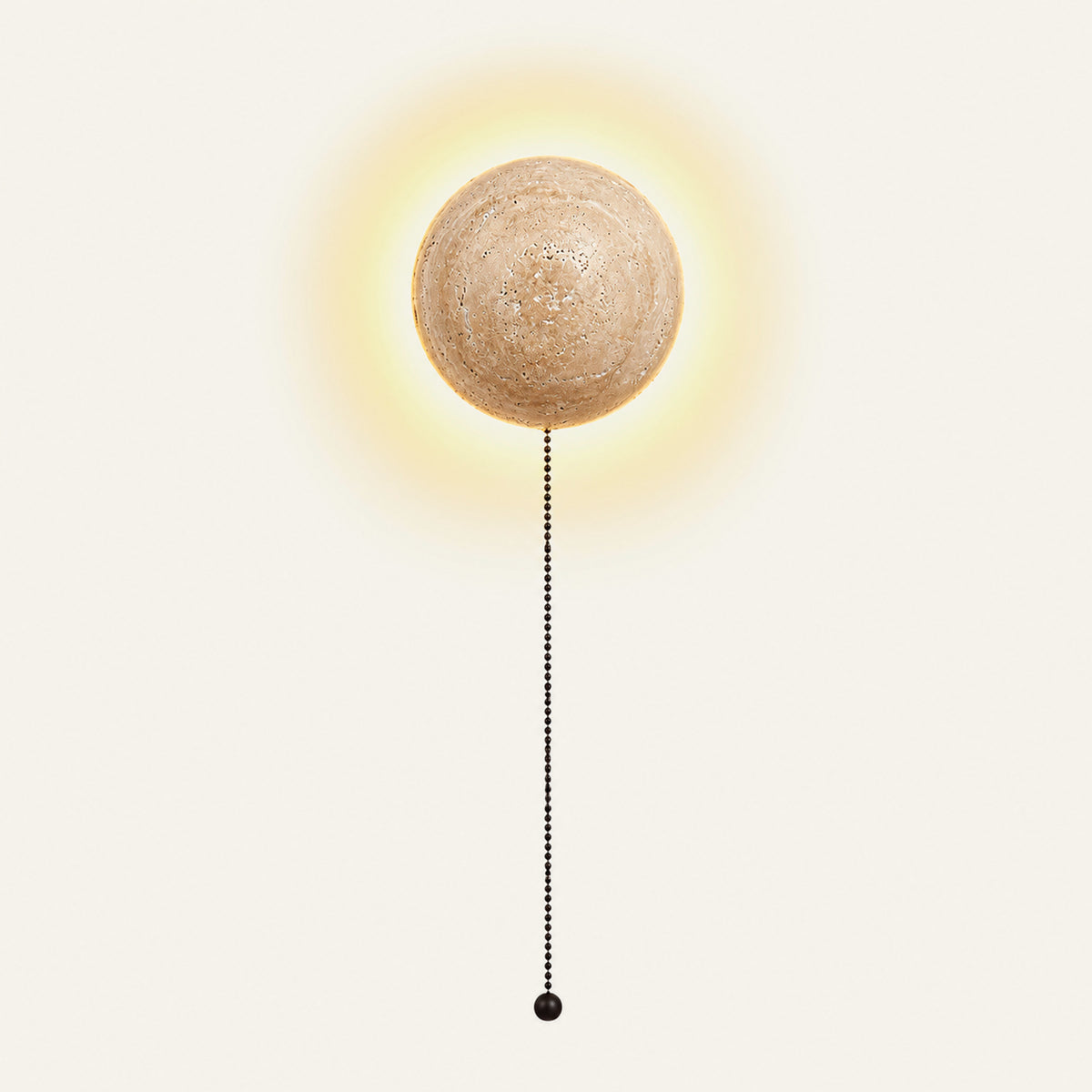 The Sole travertine wall light with a pull-chain switch