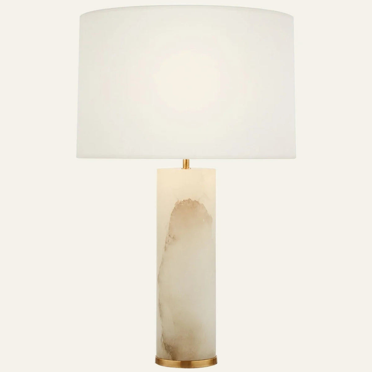 The Strata alabaster table lamp in brass, a solid stone column with a white drum shade