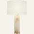 The Strata alabaster table lamp in brass, a solid stone column with a white drum shade