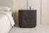 The Bevagna Fluted Marble Bedside Table in a bedroom setting