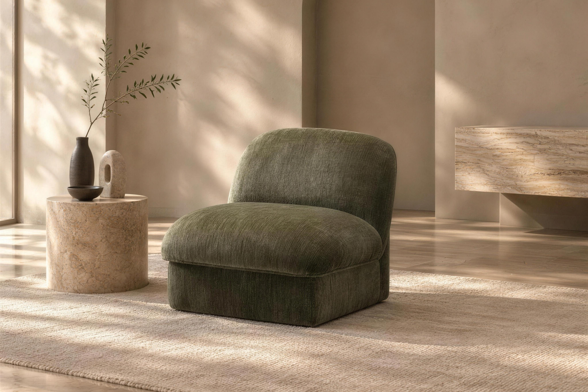 The Bosco Accent Chair in sage green chenille in a plaster-walled living room