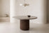 The Chiusi Travertine Round Dining Table in a dining room setting