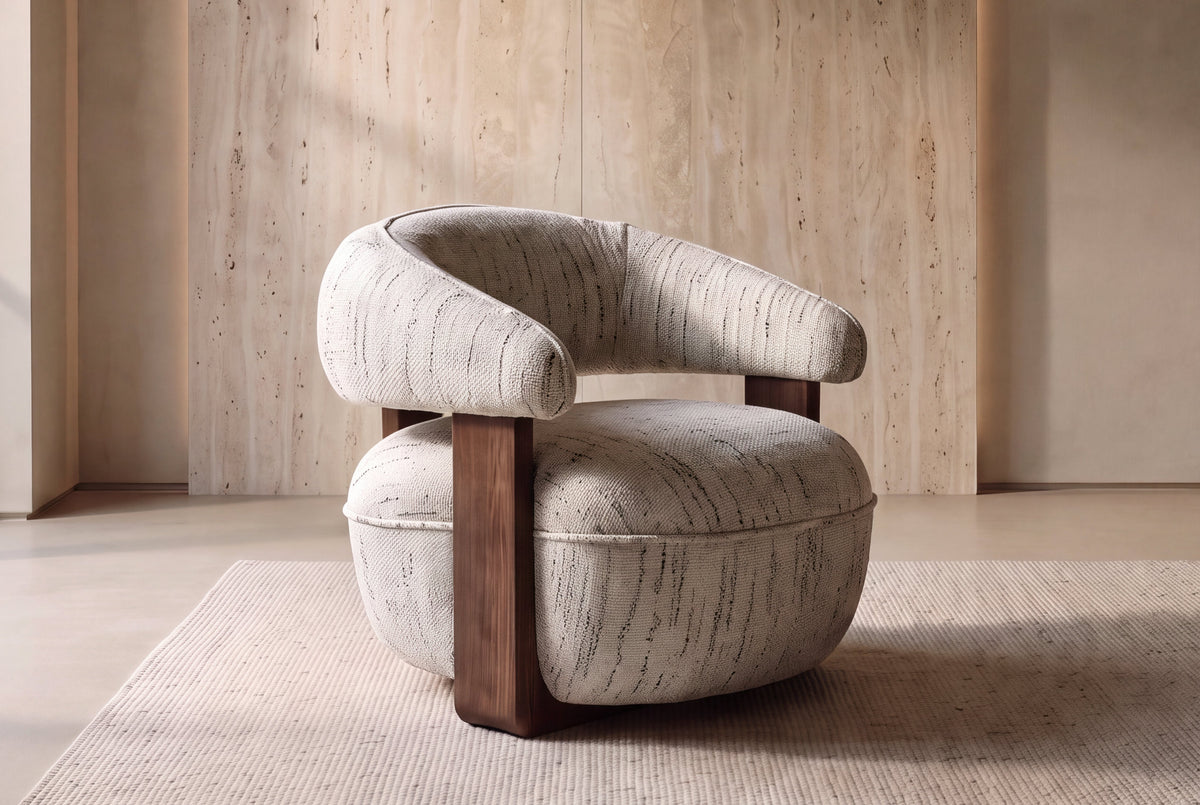 The Lerici Accent Chair in natural textured weave with walnut finish sides in a travertine-walled room